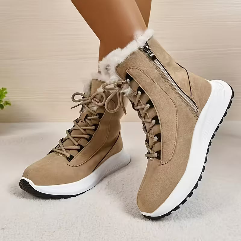 Beige winter boots with white soles on a neutral background