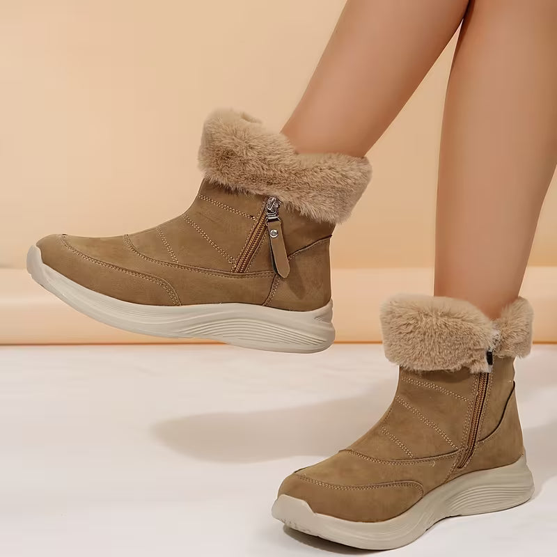 Brown winter boots with fur trim worn by a person on a beige background