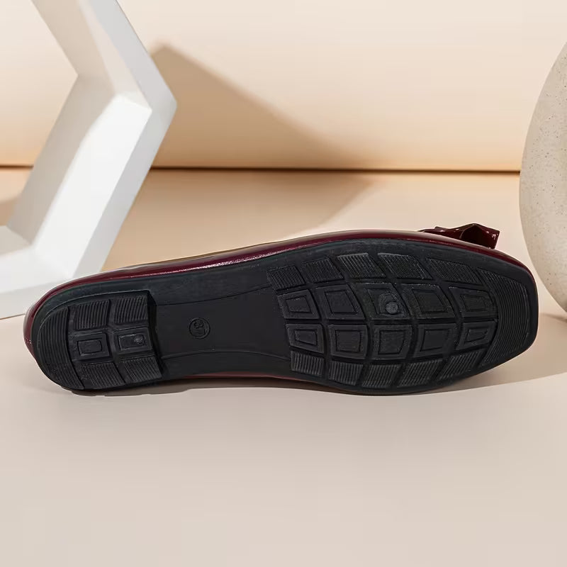 Black shoe sole on a light wooden floor